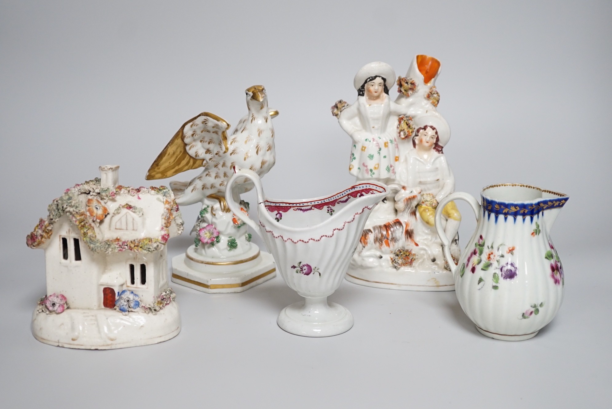 A Worcester milk jug, c.1780, a Newhall-type cream jug, c.1795, a Staffordshire porcelain model of an eagle, c.1830-40, 17cm high, and two Staffordshire porcellaneous models